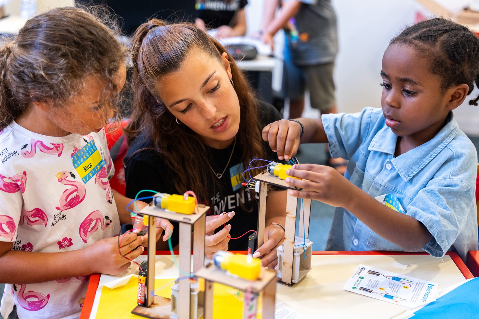 Children building motorized wooden models