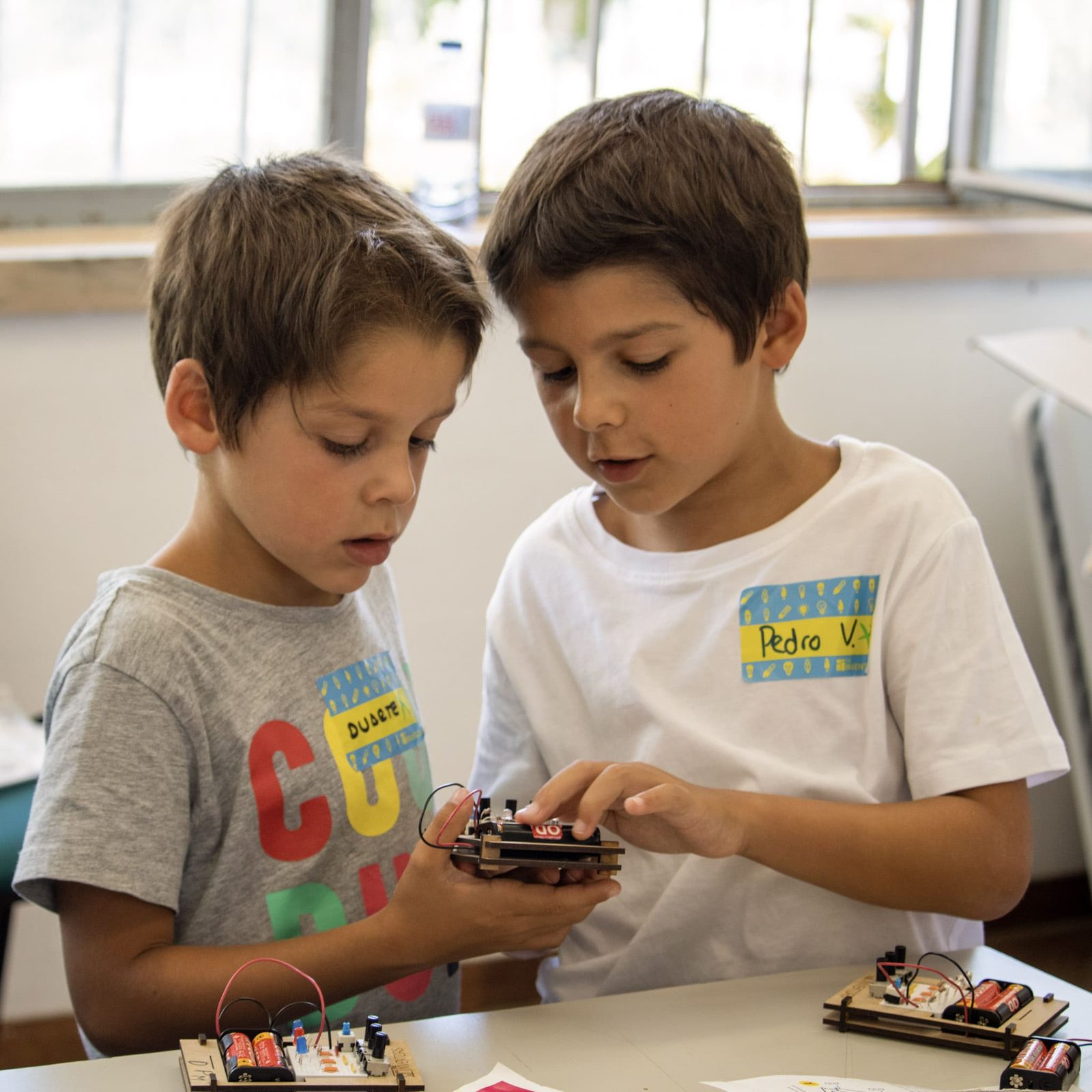 Two boys assembling a circuit